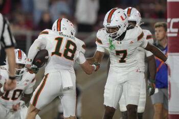 Sep 4, 2026; Stanford, California, USA;  Miami Hurricanes wide receiver Cooper Barkate (18) reacts with wide receiver Daylyn Upshaw (7) after catching a touchdown pass against the Stanford Cardinal during the third quarter at Stanford Stadium.  Mandatory Credit: Stan Szeto-Imagn Images