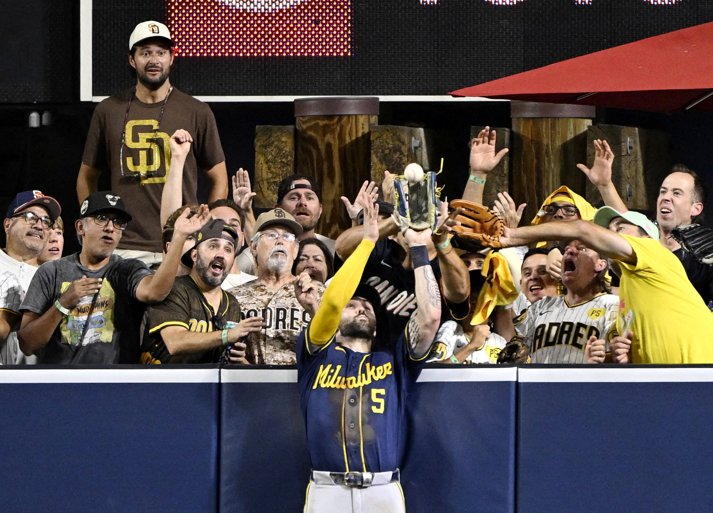 Oct 7, 2026; San Diego, California, USA;  Milwaukee Brewers center fielder Garrett Mitchell (5) catches a ball hit by San Diego Padres third baseman Manny Machado (not pictured) at the wall during the eighth inning in game four of the NLDS for the 2026 MLB Playoffs at Petco Park.  Mandatory Credit: Denis Poroy-Imagn Images     TPX IMAGES OF THE DAY