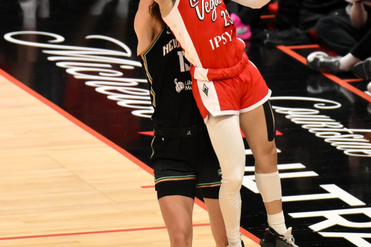 Jun 30, 2026; Brooklyn, New York, USA; Las Vegas Aces guard Chennedy Carter (23) shoots the ball while defended by New York Liberty forward Leonie Fiebich (13) during the second half at Barclays Center. Mandatory Credit: John Jones-Imagn Images