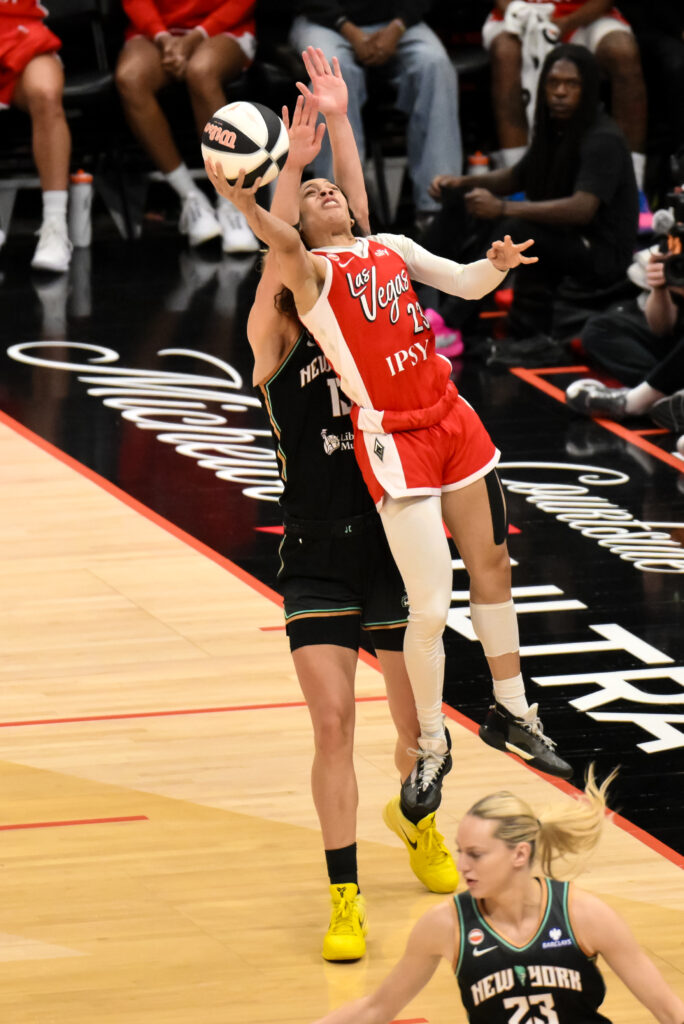 Jun 30, 2026; Brooklyn, New York, USA; Las Vegas Aces guard Chennedy Carter (23) shoots the ball while defended by New York Liberty forward Leonie Fiebich (13) during the second half at Barclays Center. Mandatory Credit: John Jones-Imagn Images