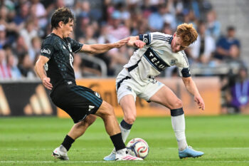 Jul 25, 2026; Saint Paul, Minnesota, USA; Minnesota United FC midfielder Wil Trapp (20) and Vancouver Whitecaps FC midfielder Oliver Larraz (8) battle for the ball during the first half at Allianz Field. Mandatory Credit: Jeffrey Becker-Imagn Images