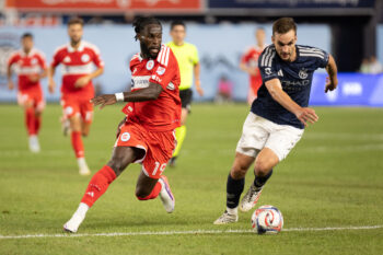 Jul 25, 2026; New York, New York, USA; Chicago Fire FC offense Jonathan Bamba (19) and New York City Football Club defense James Sands (6) go for the ball during the second half at Yankee Stadium. Mandatory Credit: Thomas Salus-Imagn Images