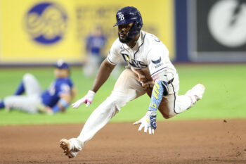 Jul 28, 2026; St. Petersburg, Florida, USA; Tampa Bay Rays third baseman Junior Caminero (13) slides into third base on an rbi triple against the Texas Rangers in the sixth inning at Tropicana Field. Mandatory Credit: Nathan Ray Seebeck-Imagn Images