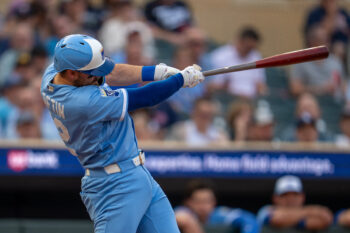 Jul 29, 2026; Minneapolis, Minnesota, USA; Kansas City Royals third baseman Nick Loftin (12) hits a RBI sacrifice fly against the Minnesota Twins in the fourth inning at Target Field. Mandatory Credit: Jesse Johnson-Imagn Images