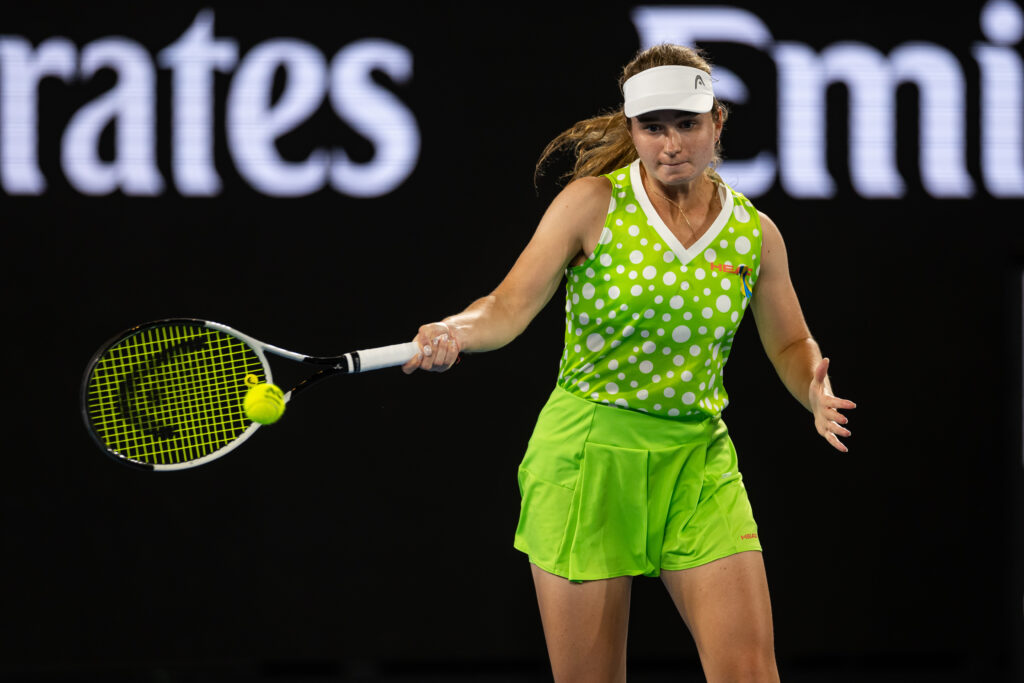 Jan 13, 2025; Melbourne, Victoria, Australia; Daria Snigur of Ukraine hits a forehand during her match against Danielle Collins of United States of America in the first round of the men's singles at the 2025 Australian Open at Melbourne Park. Mandatory Credit: Mike Frey-Imagn Images