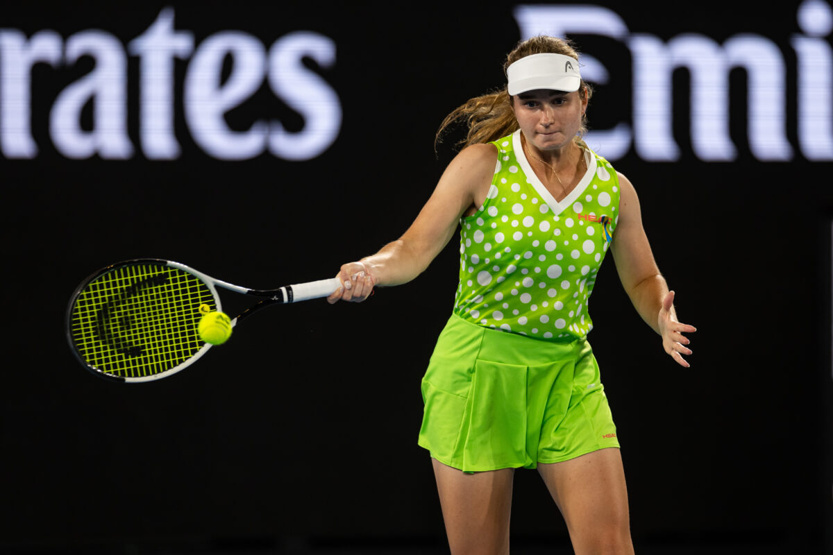 Jan 13, 2025; Melbourne, Victoria, Australia; Daria Snigur of Ukraine hits a forehand during her match against Danielle Collins of United States of America in the first round of the men's singles at the 2025 Australian Open at Melbourne Park. Mandatory Credit: Mike Frey-Imagn Images
