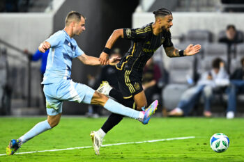 Jun 8, 2025; Los Angeles, California, USA; Sporting Kansas City defender Jansen Miller (15) trips up LAFC forward Denis Bouanga (99) during the second half at BMO Stadium. Mandatory Credit: Kelvin Kuo-Imagn Images