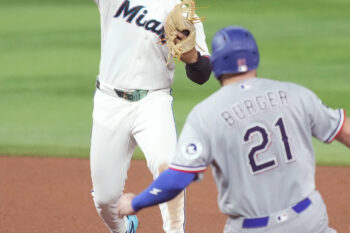 Jun 22, 2026; Miami, Florida, USA;  Miami Marlins second baseman Xavier Edwards (9) turns a double play as Texas Rangers Jake Burger (21) slides into second base at loanDepot Park. Mandatory Credit: Jim Rassol-Imagn Images