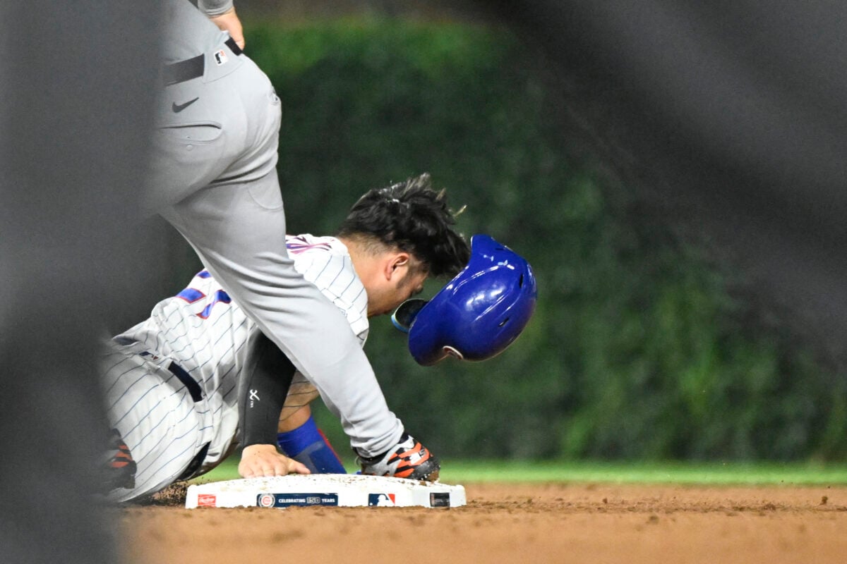 Jul 20, 2026; Chicago, Illinois, USA;  Chicago Cubs right fielder Seiya Suzuki (27) loses his helmet after being picked off on a steal during the fifth inning against the Detroit Tigers at Wrigley Field. Mandatory Credit: Matt Marton-Imagn Images