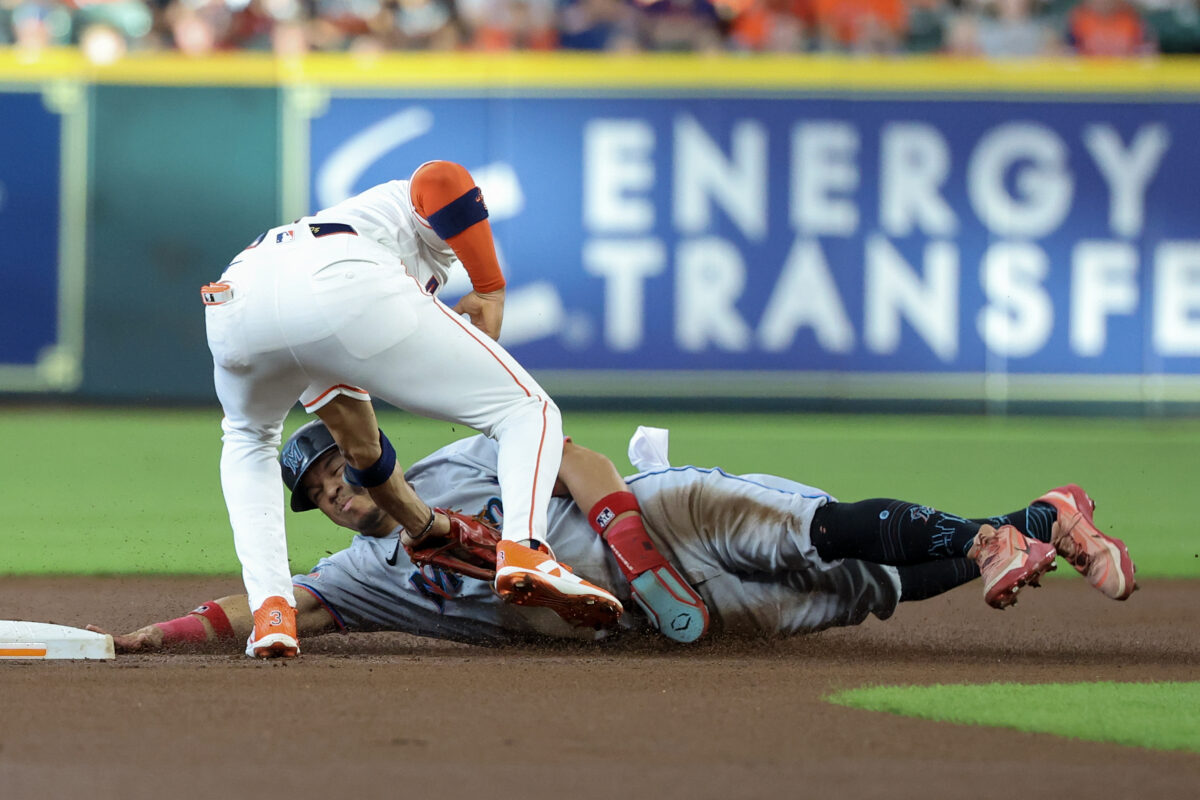 Jul 21, 2026; Houston, Texas, USA; Miami Marlins left fielder Heriberto Hernández (13) is safe at second as Houston Astros shortstop Jeremy Pena (3) makes the tag but Houston Astros designated hitter Yordan Alvarez (44) was called for a bulk  in the first inning  inning at Daikin Park. Mandatory Credit: Thomas Shea-Imagn Images