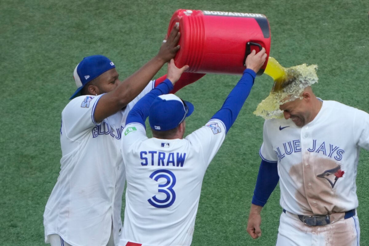 Jul 23, 2026; Toronto, Ontario, CAN; Toronto Blue Jays designated hitter George Springer (4) gets doused with a sport drink by first baseman Vladimir Guerrero Jr. (27) and center fielder Myles Straw (3) following a win over the Tampa Bay Rays during the ninth inning at Rogers Centre. Mandatory Credit: John E. Sokolowski-Imagn Images