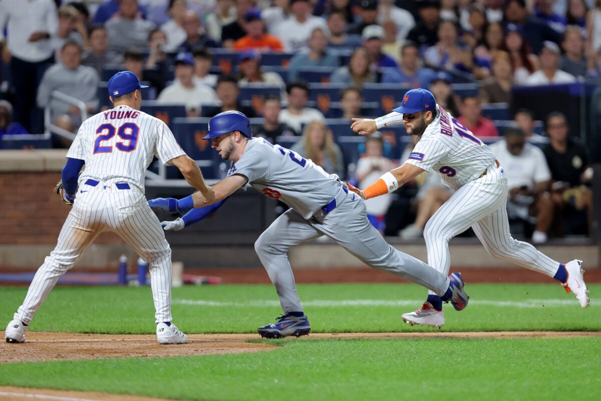 Jul 24, 2026; New York City, New York, USA; Los Angeles Dodgers right fielder Kyle Tucker (23) is tagged out by New York Mets third baseman Bo Bichette (19) in front of Mets first baseman Jared Young (29) after getting caught in a run-down on a bunt by Dodgers catcher Dalton Rushing (not pictured) during the seventh inning at Citi Field. Mandatory Credit: Brad Penner-Imagn Images