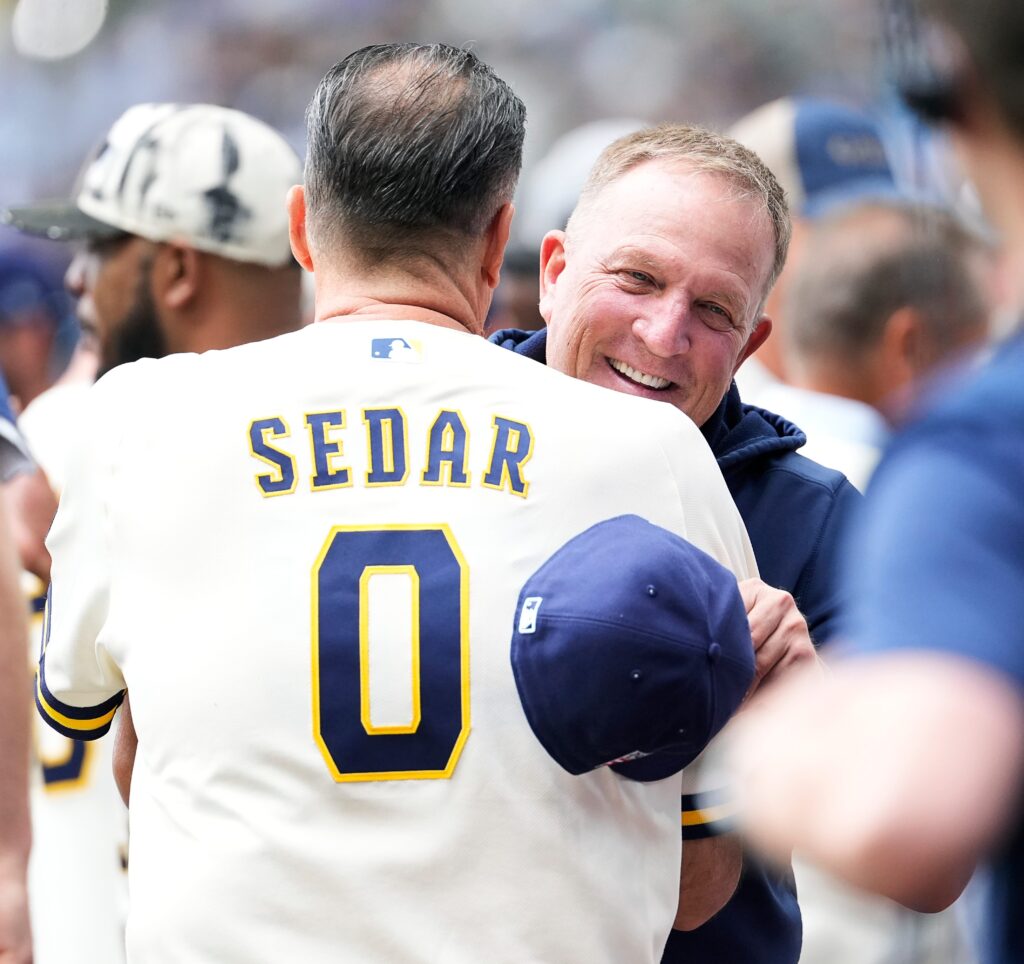 Milwaukee Brewers manager Pat Murphy (49) greets former baseball coach Ed Sedar (0) before the start of the Milwaukee Brewers and Colorado Rockies game at American Family Field in Milwaukee, Wisconsin on July 24, 2026.