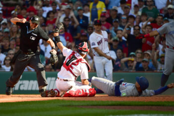 Jul 25, 2026; Boston, Massachusetts, USA;  Boston Red Sox catcher Connor Wong (12) tags out Toronto Blue Jays shortstop Andres Gimenez (0) at home plate during the fourth inning at Fenway Park. Mandatory Credit: Bob DeChiara-Imagn Images