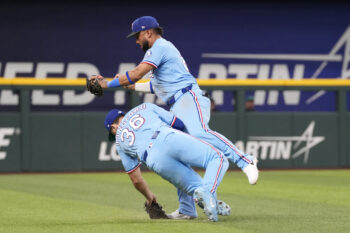 Jul 26, 2026; Arlington, Texas, USA; Texas Rangers shortstop Ezequiel Duran (20) collides into left fielder Wyatt Langford (36) after catching the fly-out hit by Seattle Mariners second baseman Cole Young (2) during the eighth inning at Globe Life Field. Mandatory Credit: Jim Cowsert-Imagn Images