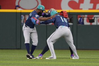 Jul 26, 2026; Arlington, Texas, USA; Seattle Mariners right fielder Victor Robles (10), left fielder Randy Arozarena (56) and right fielder Luke Raley (20) celebrate their team’s 6-4 win over the Texas Rangers following the ninth inning at Globe Life Field. Mandatory Credit: Jim Cowsert-Imagn Images