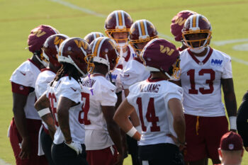 Jul 29, 2026; Ashburn, VA, USA; Washington Commanders wide receivers huddle after a drill on day one of training camp at BigBear.ai Performance Center at Commanders Park. Mandatory Credit: Geoff Burke-Imagn Images