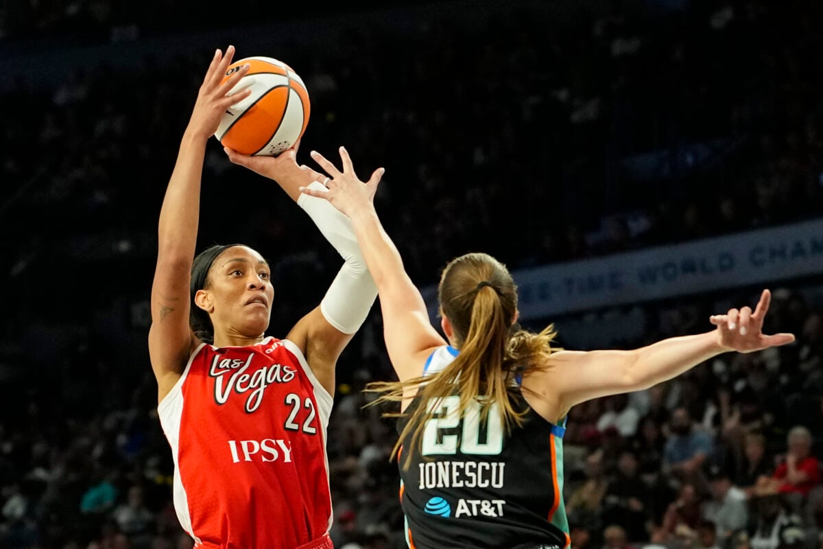 Jul 30, 2026; Las Vegas, Nevada, USA; Las Vegas Aces center A'ja Wilson (22) shoots the ball against New York Liberty guard Sabrina Ionescu (20) during the second quarter of a WNBA basketball game at Michelob Ultra Arena. Mandatory Credit: Lucas Peltier-Imagn Images