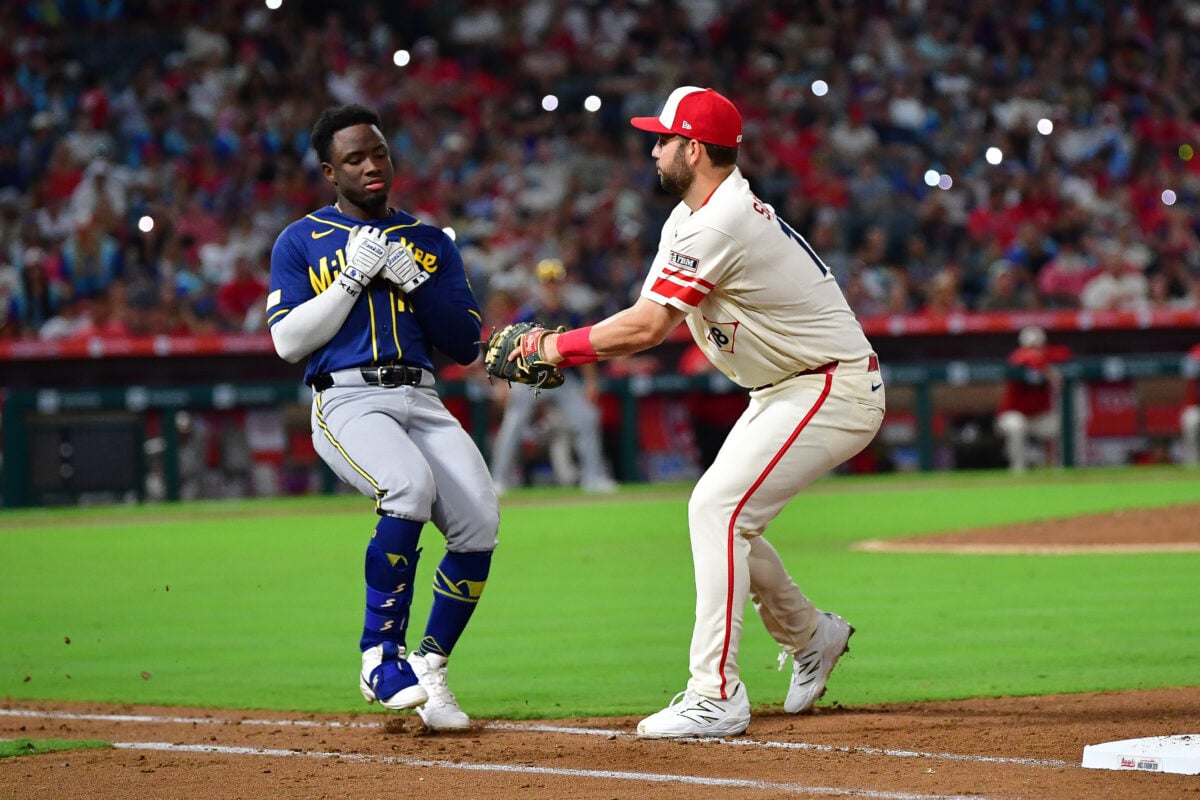 Jul 31, 2026; Anaheim, California, USA; Milwaukee Brewers right fielder Luis Lara (18) is tagged out at first by Los Angeles Angels first baseman Nolan Schanuel (18) to end the top of the seventh inning at Angel Stadium. Mandatory Credit: Gary A. Vasquez-Imagn Images