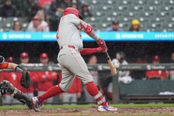 Aug 2, 2026; Baltimore, Maryland, USA; Philadelphia Phillies designated hitter Kyle Schwarber (12) hits a sacrifice fly ball against the Baltimore Orioles during the fifth inning at Oriole Park at Camden Yards. Mandatory Credit: Gregory Fisher-Imagn Images