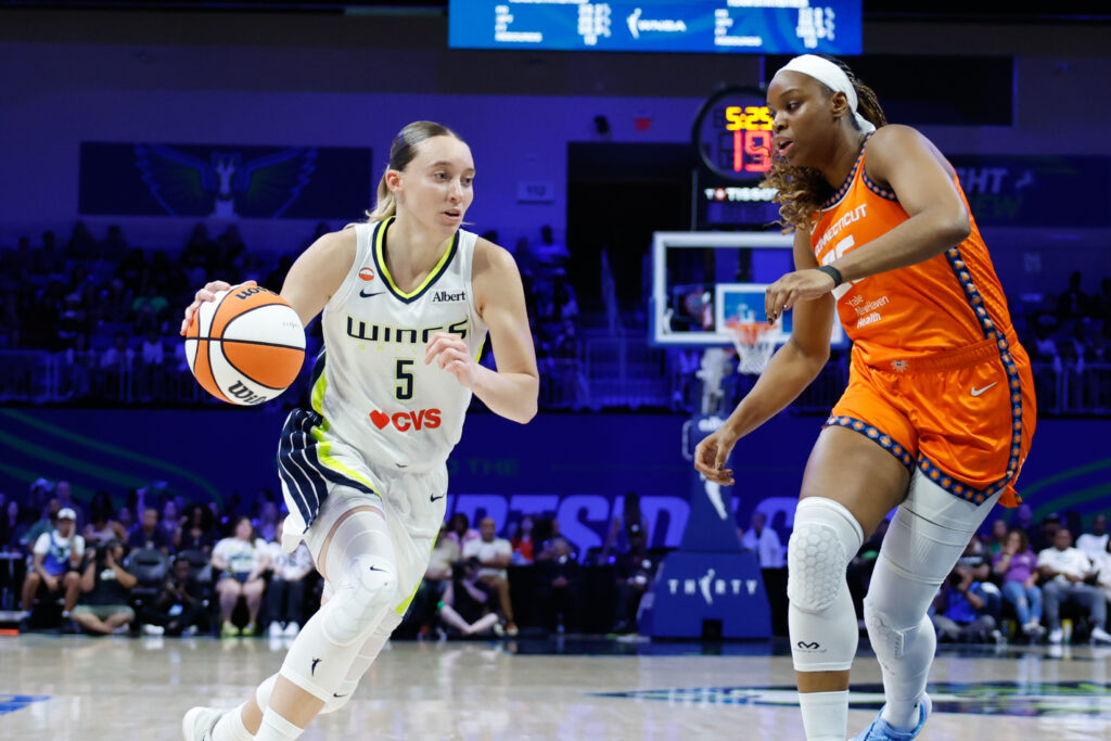 Aug 2, 2026; Arlington, Texas, USA; Dallas Wings guard Paige Bueckers (5) drives to the basket against Connecticut Sun guard-forward Kennedy Burke (25) during the first half at College Park Center. Mandatory Credit: Chris Jones-Imagn Images