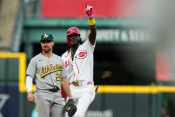 Aug 4, 2026; Cincinnati, Ohio, USA;  Cincinnati Reds shortstop Elly de la Cruz gestures as he stands at second base, after hitting a two-run single against the Athletics in the fifth inning at Great American Ball Park. Mandatory Credit: Aaron Doster-Imagn Images