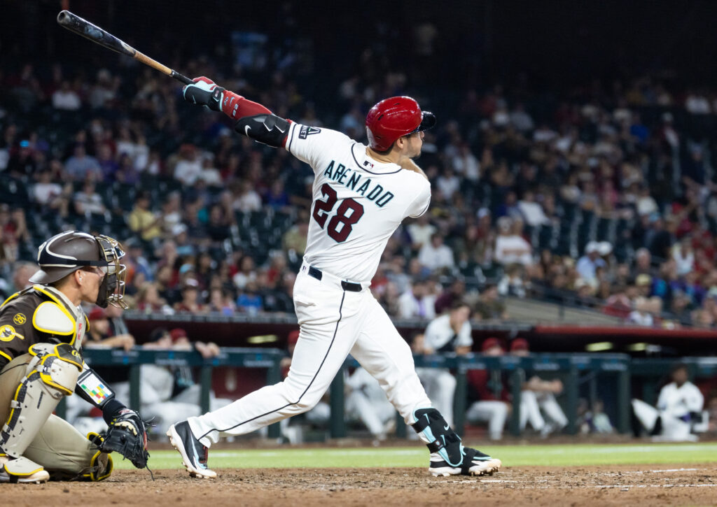 Aug 4, 2026; Phoenix, Arizona, USA; Arizona Diamondbacks third baseman Nolan Arenado hits a two run home run in the seventh inning against the San Diego Padres at Chase Field. Mandatory Credit: Mark J. Rebilas-Imagn Images