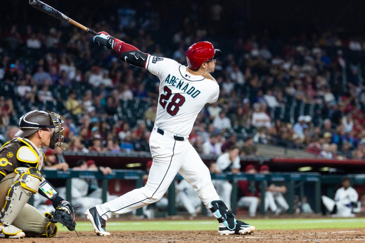 Aug 4, 2026; Phoenix, Arizona, USA; Arizona Diamondbacks third baseman Nolan Arenado hits a two run home run in the seventh inning against the San Diego Padres at Chase Field. Mandatory Credit: Mark J. Rebilas-Imagn Images