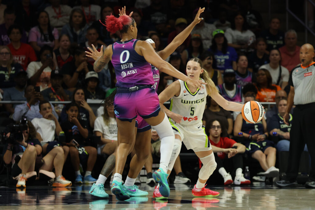 Aug 5, 2026; Washington, District of Columbia, USA; Dallas Wings guard Paige Bueckers (5) dribbles the ball as Washington Mystics guard Cotie McMahon (23) and Mystics center Shakira Austin (0) defend in the second half at CareFirst Arena. Mandatory Credit: Geoff Burke-Imagn Images
