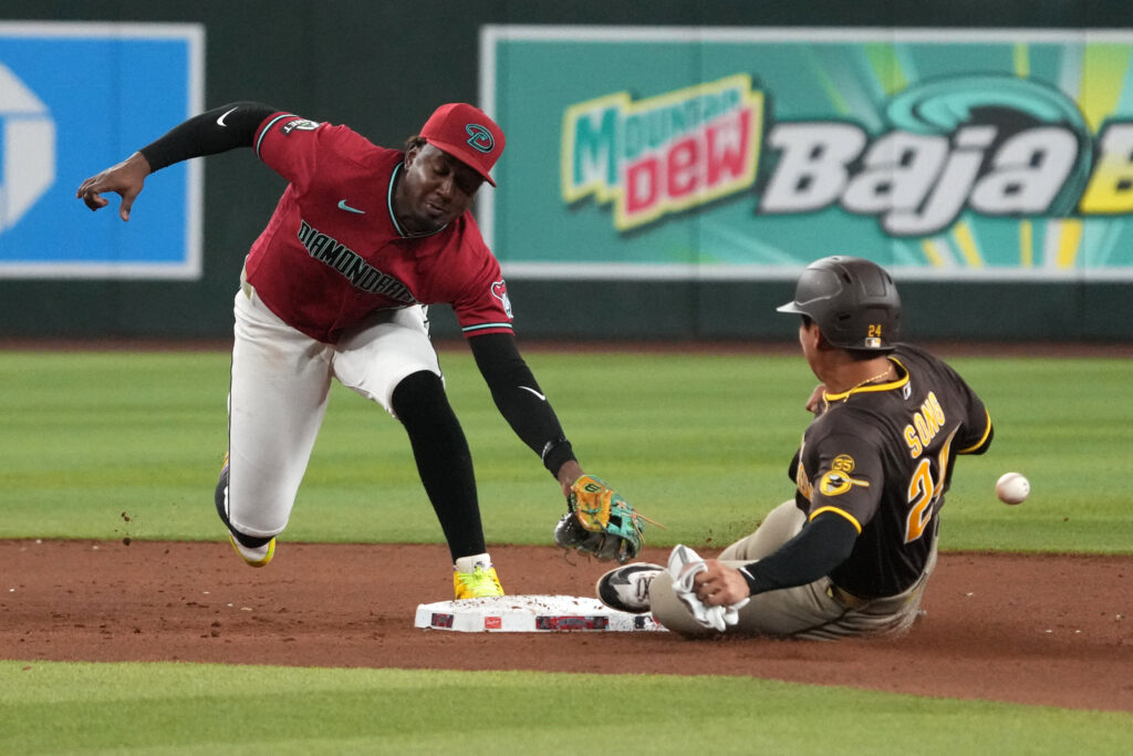 Aug 5, 2026; Phoenix, Arizona, USA; Arizona Diamondbacks shortstop Geraldo Perdomo (2) tries to tag out San Diego Padres second baseman Sung-Mun Song (24) in the ninth inning at Chase Field. Mandatory Credit: Rick Scuteri-Imagn Images