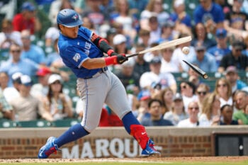 Aug 6, 2026; Chicago, Illinois, USA; Toronto Blue Jays first baseman Kazuma Okamoto (7) singles against the Chicago Cubs as he breaks his bat during the third inning at Wrigley Field. Mandatory Credit: Kamil Krzaczynski-Imagn Images