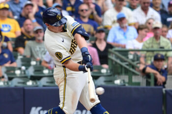 Aug 6, 2026; Milwaukee, Wisconsin, USA; Milwaukee Brewers first baseman Andrew Vaughn (28) drives in a run with a base hit in the fifth inning against the Pittsburgh Pirates at American Family Field. Mandatory Credit: Benny Sieu-Imagn Images