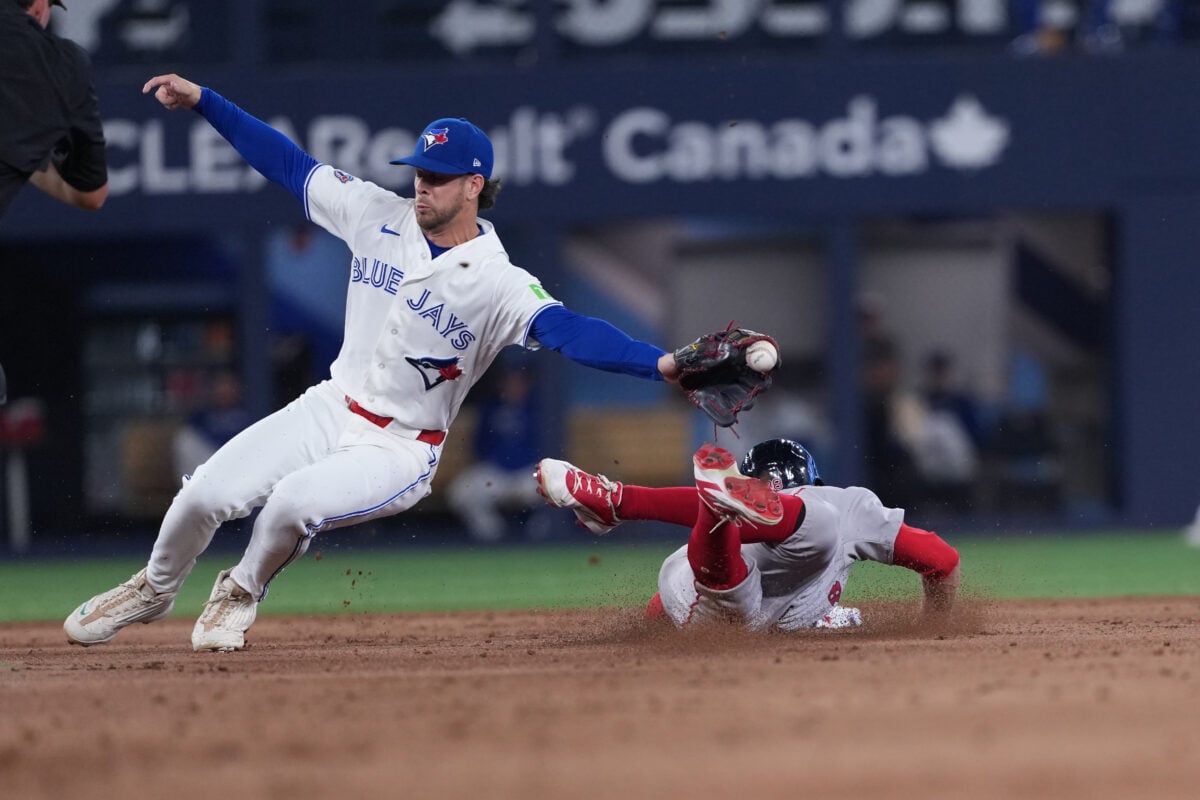 Aug 10, 2026; Toronto, Ontario, CAN; Boston Red Sox pinch run Eli White (38) slides into second base safe ahead of the tag from Toronto Blue Jays second baseman Ernie Clement (22) during the eighth inning against the at Rogers Centre. Mandatory Credit: Nick Turchiaro-Imagn Images