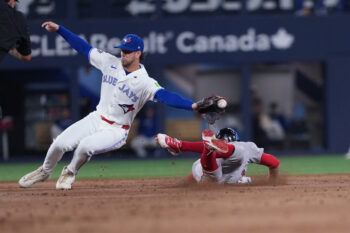 Aug 10, 2026; Toronto, Ontario, CAN; Boston Red Sox pinch run Eli White (38) slides into second base safe ahead of the tag from Toronto Blue Jays second baseman Ernie Clement (22) during the eighth inning against the at Rogers Centre. Mandatory Credit: Nick Turchiaro-Imagn Images