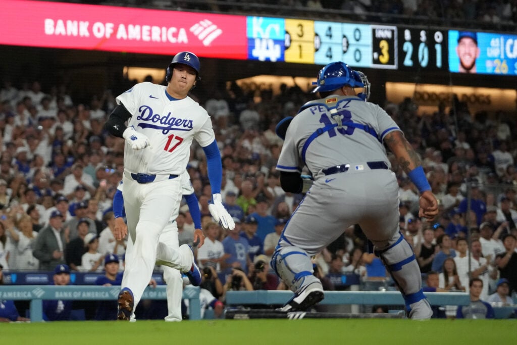 Aug 10, 2026; Los Angeles, California, USA; Los Angeles Dodgers Shohei Ohtani (17) beats a throw to Kansas City Royals two-way player Salvador Perez (13) to score in the seventh inning at Dodger Stadium. Mandatory Credit: Kirby Lee-Imagn Images