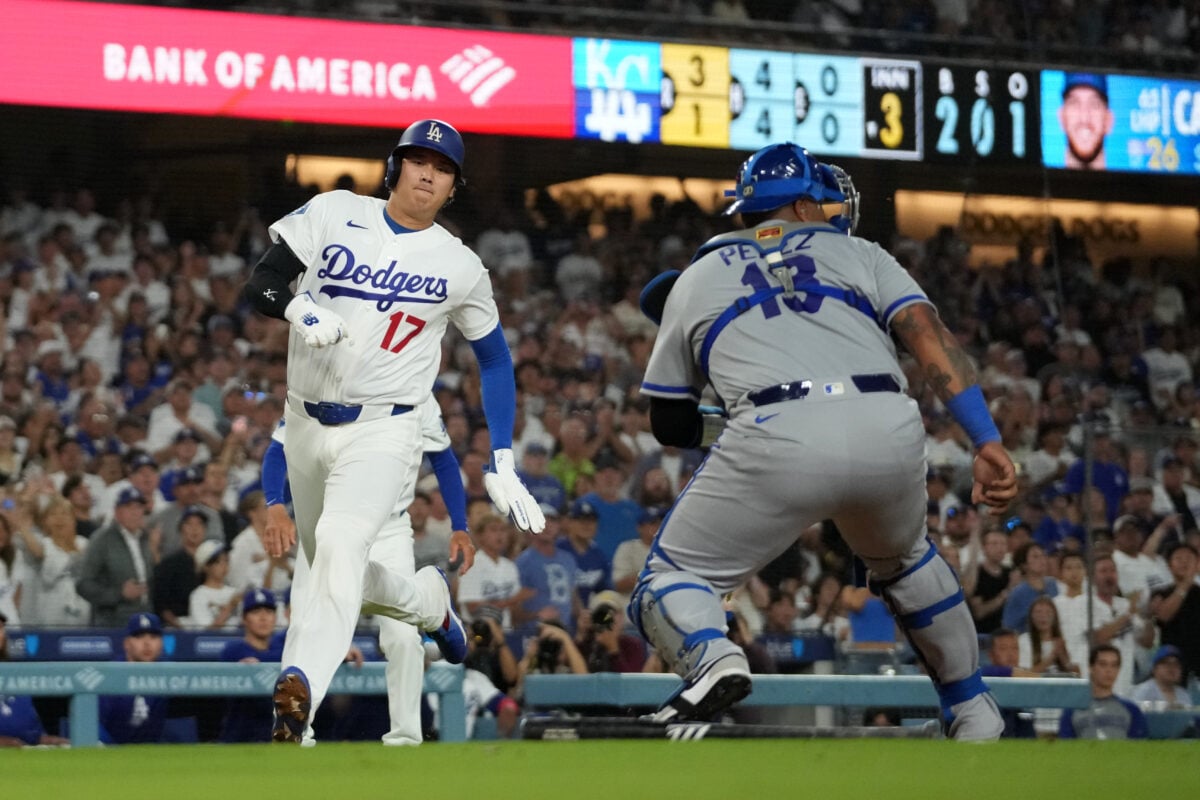 Aug 10, 2026; Los Angeles, California, USA; Los Angeles Dodgers Shohei Ohtani (17) beats a throw to Kansas City Royals two-way player Salvador Perez (13) to score in the seventh inning at Dodger Stadium. Mandatory Credit: Kirby Lee-Imagn Images