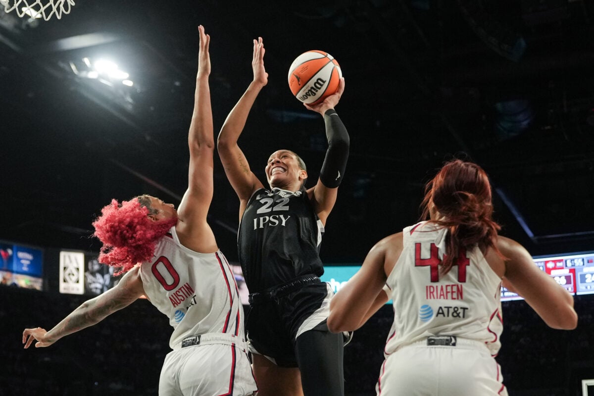 Aug 11, 2026; Las Vegas, Nevada, USA; Las Vegas Aces center A'ja Wilson (22) shoots the ball against Washington Mystics center Shakira Austin (0) and forward Kiki Iriafen (44) during the second quarter of a WNBA basketball game at Michelob Ultra Arena. Mandatory Credit: Lucas Peltier-Imagn Images