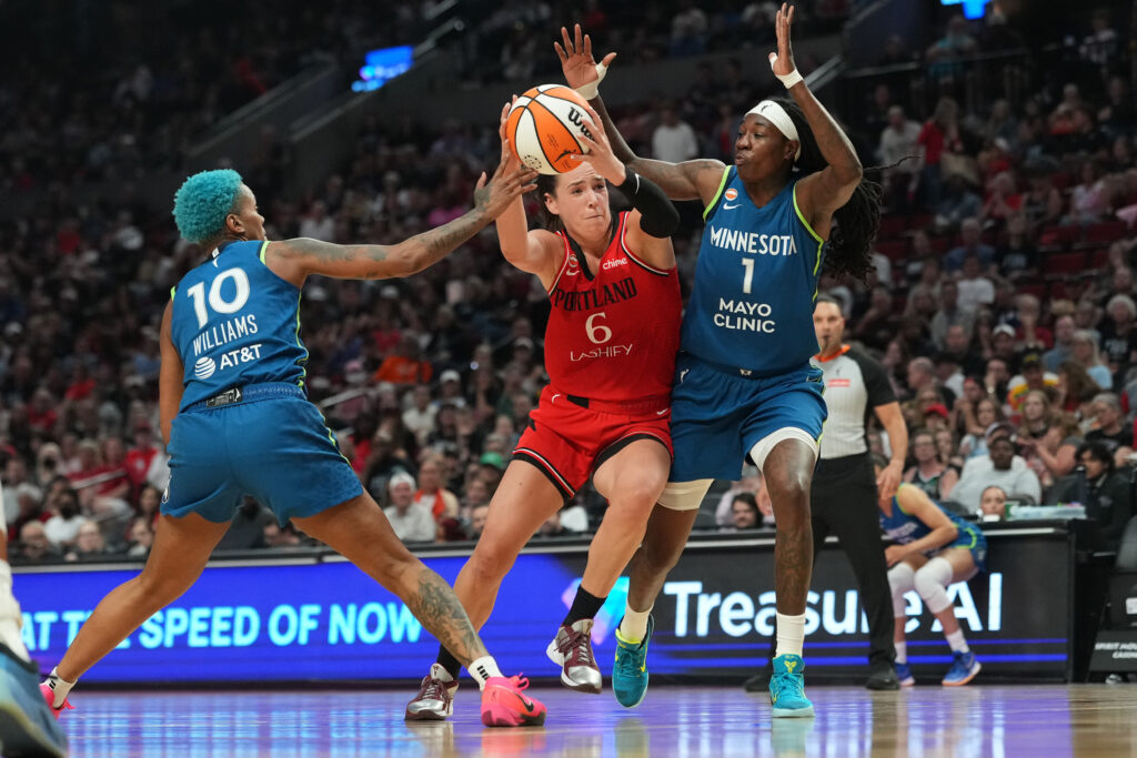 Aug 12, 2026; Portland, Oregon, USA; Portland Fire forward Bridget Carleton (6) drives to the basket between Minnesota Lynx guard Courtney Williams (10) and forward Natasha Howard (1) during the second half at Moda Center. Mandatory Credit: Soobum Im-Imagn Images