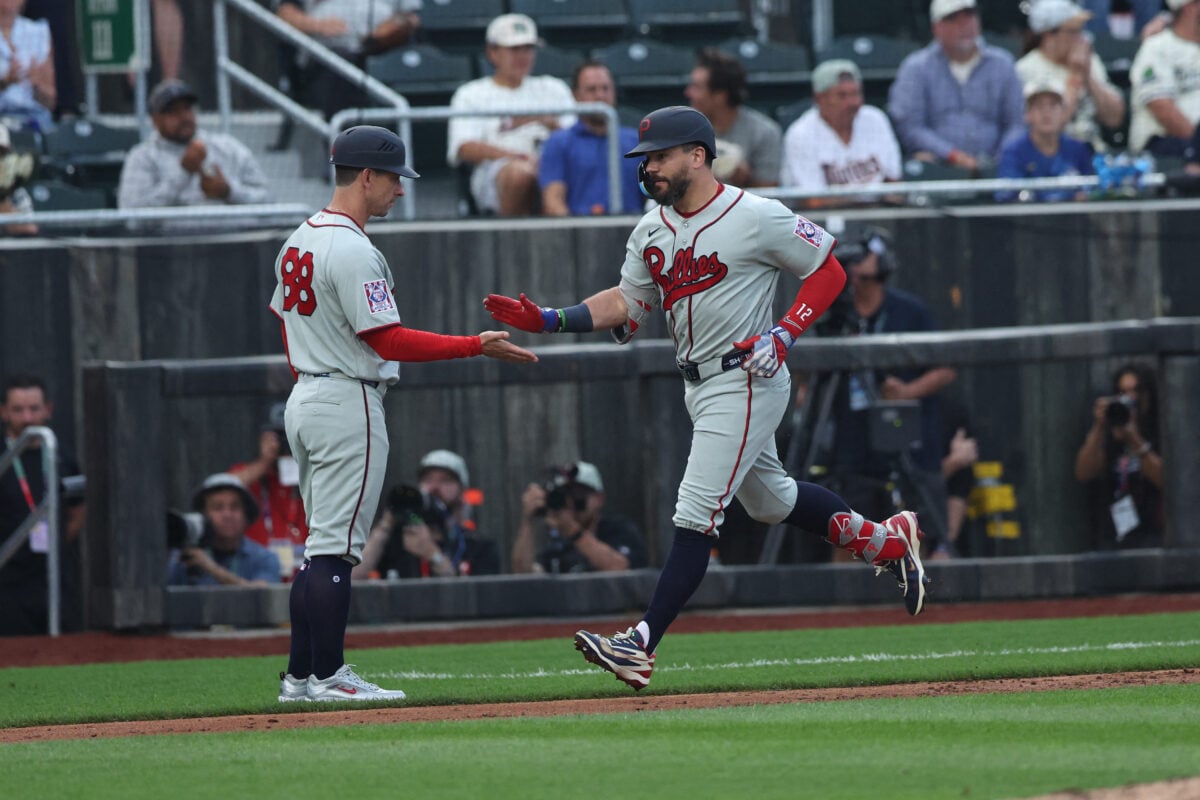 Aug 13, 2026; Dyersville, Iowa, USA; Philadelphia Phillies designated hitter Kyle Schwarber (12) celebrates with Philadelphia Phillies third base coach Anthony Contreras (88) after hitting his second home run against the Minnesota Twins at the Field of Dreams. Mandatory Credit: Reese Strickland-Imagn Images