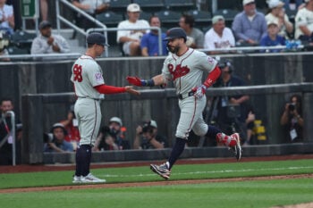 Aug 13, 2026; Dyersville, Iowa, USA; Philadelphia Phillies designated hitter Kyle Schwarber (12) celebrates with Philadelphia Phillies third base coach Anthony Contreras (88) after hitting his second home run against the Minnesota Twins at the Field of Dreams. Mandatory Credit: Reese Strickland-Imagn Images