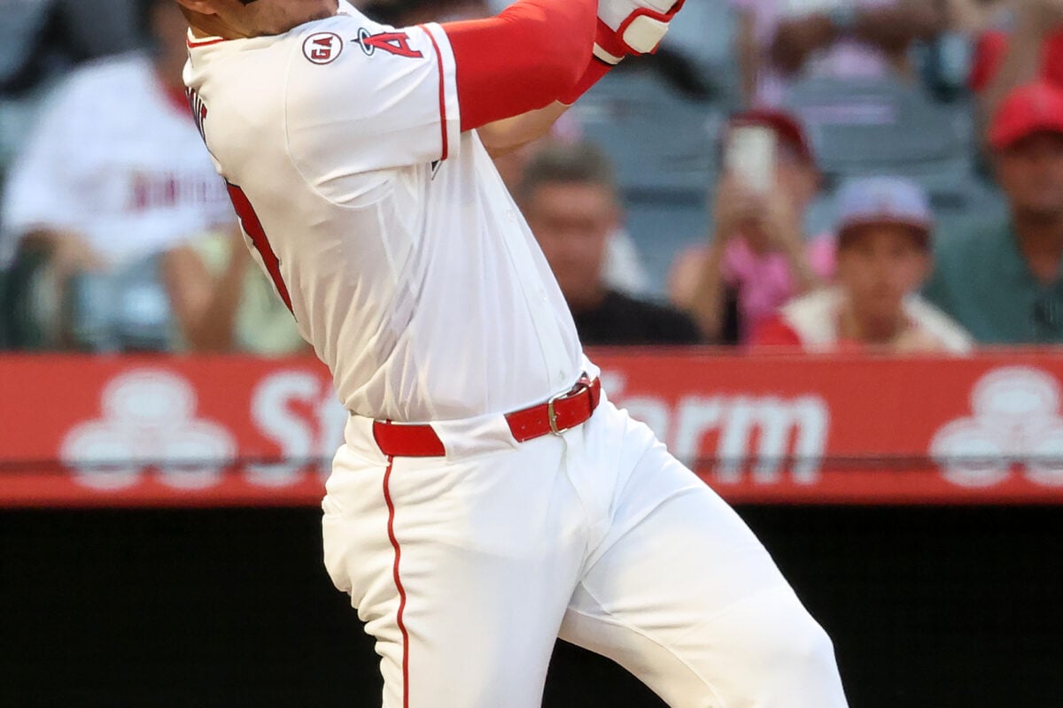 Aug 13, 2026; Anaheim, California, USA;  Los Angeles Angels center fielder Mike Trout (27) hits a single during the first inning against the Texas Rangers at Angel Stadium. Mandatory Credit: Kiyoshi Mio-Imagn Images