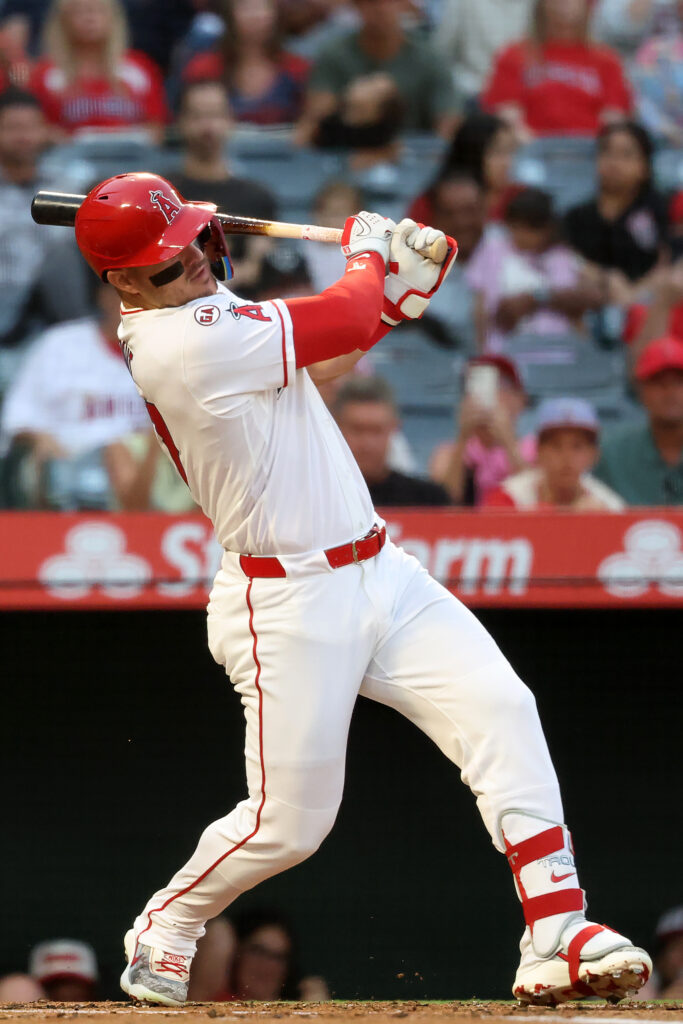 Aug 13, 2026; Anaheim, California, USA;  Los Angeles Angels center fielder Mike Trout (27) hits a single during the first inning against the Texas Rangers at Angel Stadium. Mandatory Credit: Kiyoshi Mio-Imagn Images