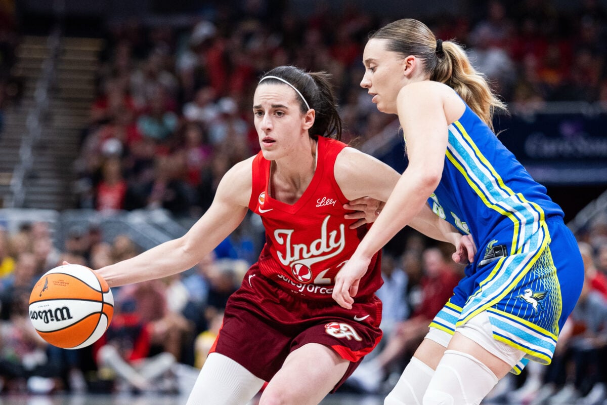 Aug 14, 2026; Indianapolis, Indiana, USA;  Indiana Fever guard Caitlin Clark (22) dribbles the ball while Dallas Wings guard Paige Bueckers (5) defends in the first half at Gainbridge Fieldhouse. Mandatory Credit: Trevor Ruszkowski-Imagn Images