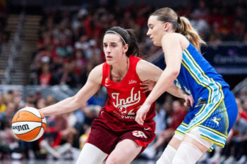 Aug 14, 2026; Indianapolis, Indiana, USA;  Indiana Fever guard Caitlin Clark (22) dribbles the ball while Dallas Wings guard Paige Bueckers (5) defends in the first half at Gainbridge Fieldhouse. Mandatory Credit: Trevor Ruszkowski-Imagn Images