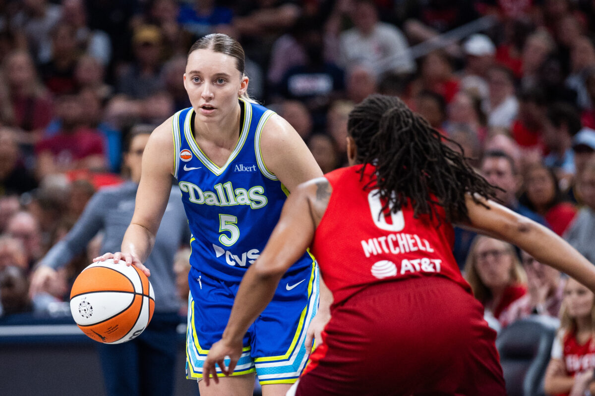 Aug 14, 2026; Indianapolis, Indiana, USA;  Dallas Wings guard Paige Bueckers (5) dribbles the ball while  Indiana Fever guard Kelsey Mitchell (0) defends in the second half at Gainbridge Fieldhouse. Mandatory Credit: Trevor Ruszkowski-Imagn Images