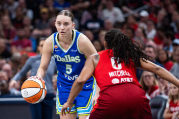 Aug 14, 2026; Indianapolis, Indiana, USA;  Dallas Wings guard Paige Bueckers (5) dribbles the ball while  Indiana Fever guard Kelsey Mitchell (0) defends in the second half at Gainbridge Fieldhouse. Mandatory Credit: Trevor Ruszkowski-Imagn Images