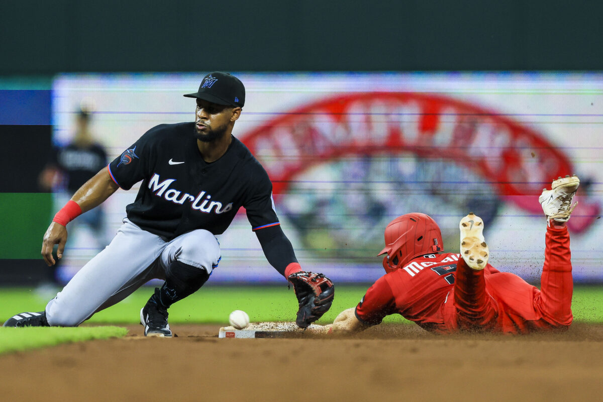 Aug 15, 2026; Cincinnati, Ohio, USA; Cincinnati Reds second baseman Matt McLain (9) steals second against Miami Marlins shortstop Otto Lopez (6) in the seventh inning at Great American Ball Park. Mandatory Credit: Katie Stratman-Imagn Images