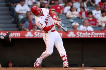 Aug 15, 2026; Anaheim, California, USA;  Los Angeles Angels center fielder Mike Trout (27) hits a single during the first inning against the Kansas City Royals at Angel Stadium. Mandatory Credit: Kiyoshi Mio-Imagn Images
