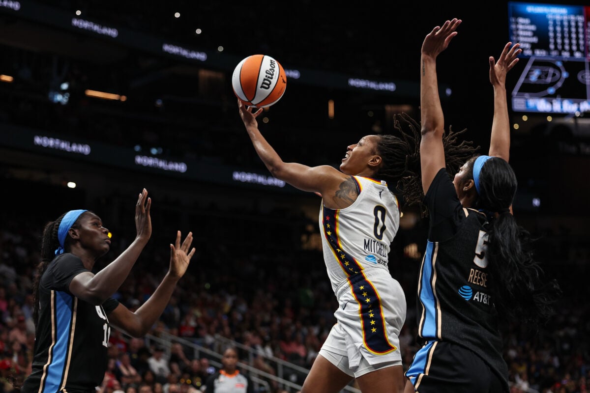 Aug 16, 2026; Atlanta, Georgia, USA; Indiana Fever guard Kelsey Mitchell (0) shoots against Atlanta Dream forward Angel Reese (5) during the first quarter at State Farm Arena. Mandatory Credit: Colin Hubbard-Imagn Images