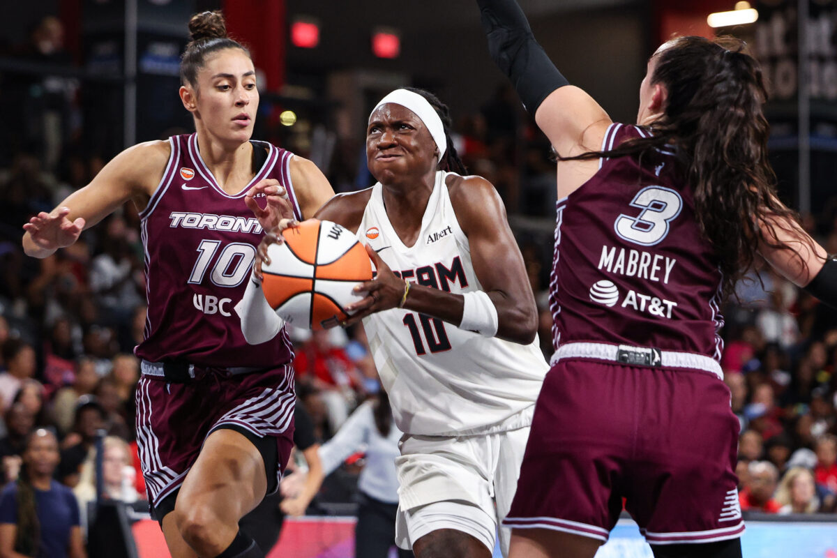 Aug 10, 2026; College Park, Georgia, USA; Atlanta Dream guard Rhyne Howard (10) drives to the basket against Toronto Tempo forward Maria Conde (10) and guard Marina Mabrey (3) in the second quarter at Gateway Center Arena at College Park. Mandatory Credit: Colin Hubbard-Imagn Images